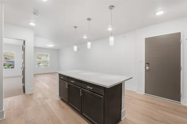 a kitchen with a stove a refrigerator and a sink