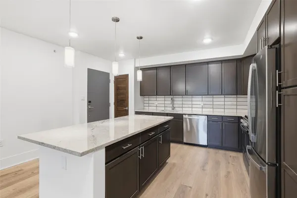 a kitchen with a sink stove and refrigerator