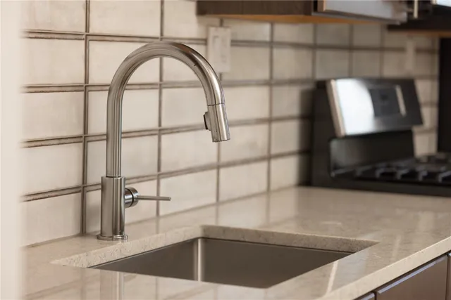 a stove top oven sitting inside of a kitchen