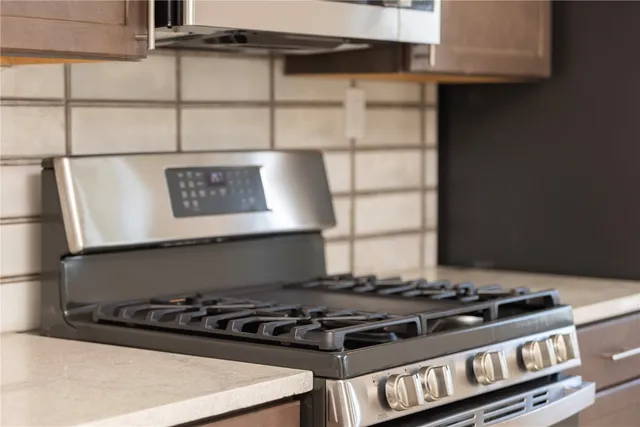 a kitchen with stainless steel appliances granite countertop a refrigerator and a microwave