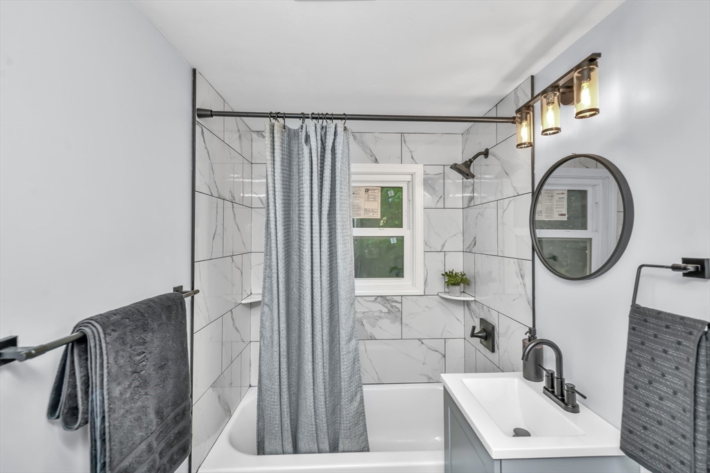 36 Dietz Road Boston, MA 02136 - Photo 16 of 31 a bathroom with a sink a mirror and a shower