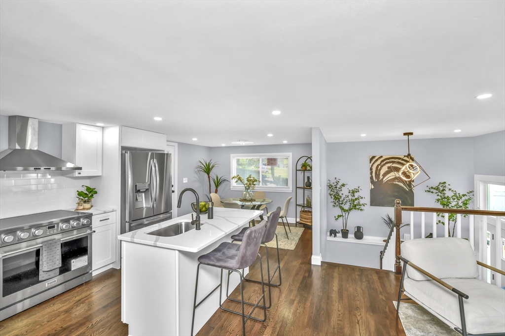 36 Dietz Road Boston, MA 02136 - Photo 2 of 31 a kitchen with a table chairs stove and wooden floor