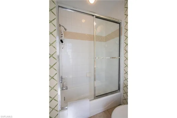 a bathroom with a shower and a sink