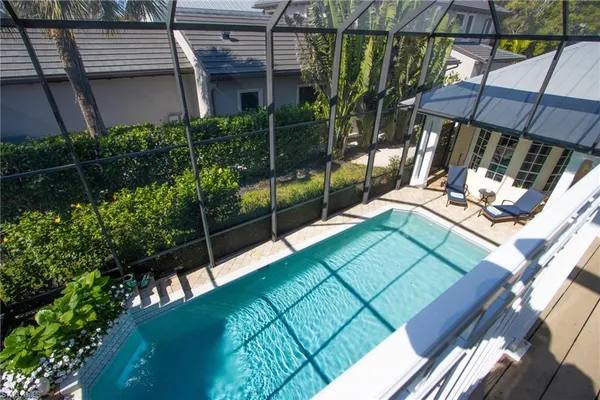 a view of yard from deck with patio