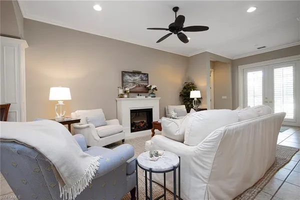 a living room with furniture a fireplace and a window