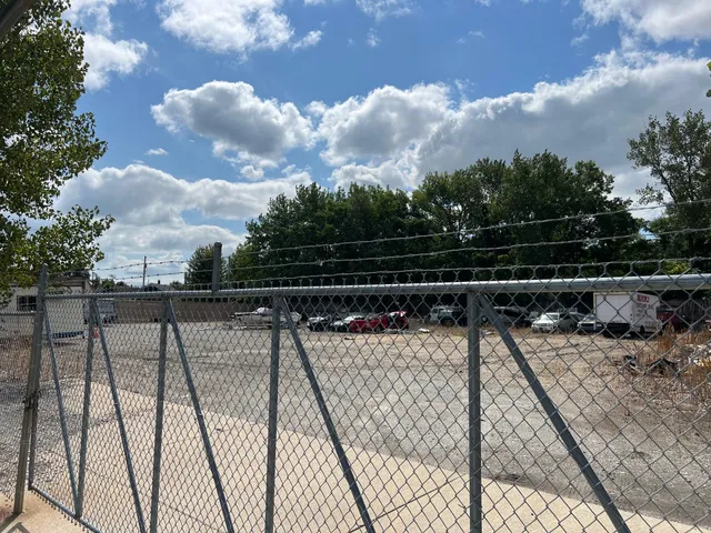 a view of roof deck with wooden floor and fence
