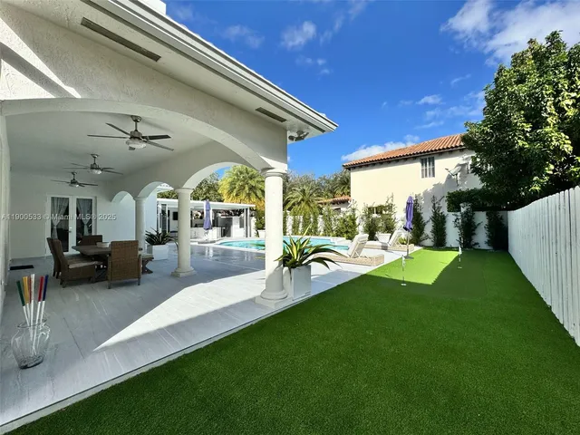 a view of a house with swimming pool and sitting area