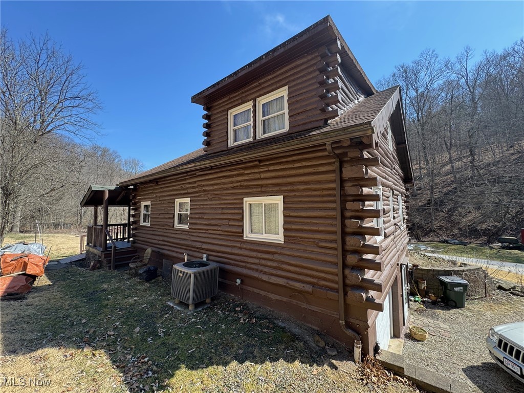57725 Nixon Run Road Martins Ferry, OH 43935 - Photo 7 of 26 View of side of property with log siding, roof with shingles, and cooling unit