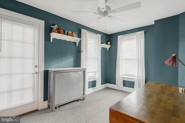 a living room with a bed furniture and a window