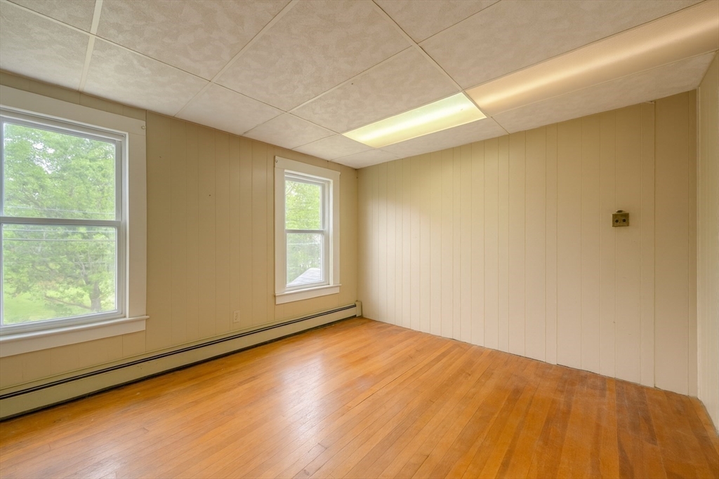 29 3rd Street Ayer, MA 01432 - Photo 14 of 29 a view of empty room with wooden floor and fan