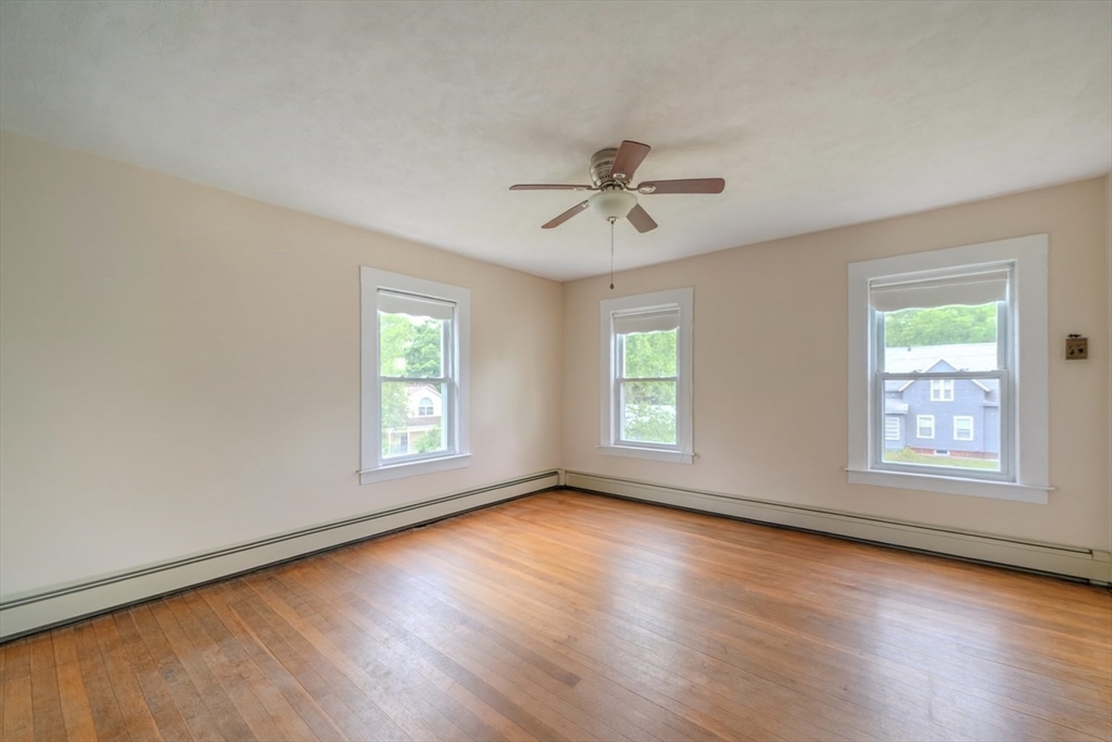 29 3rd Street Ayer, MA 01432 - Photo 15 of 29 a view of an empty room with a window and wooden floor