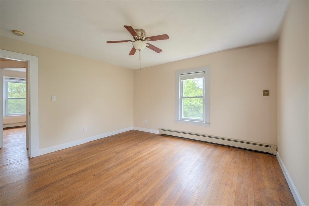 29 3rd Street Ayer, MA 01432 - Photo 16 of 29 a view of an empty room with wooden floor and a window