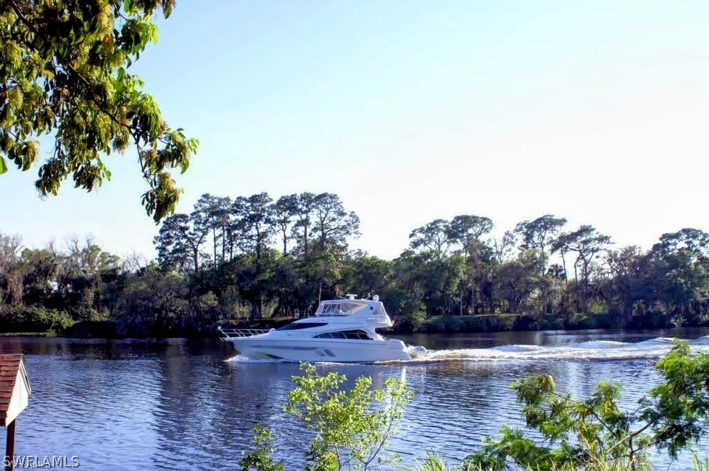 3015 Shell Lane LaBelle, FL 33935 - Photo 3 of 24 a view of a patio with table and chairs plants and trees
