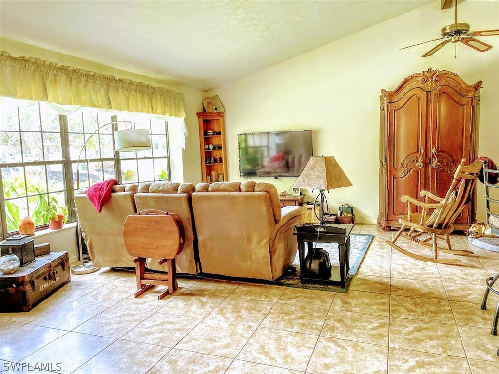 3015 Shell Lane LaBelle, FL 33935 - Photo 10 of 24 a living room with furniture and a floor to ceiling window