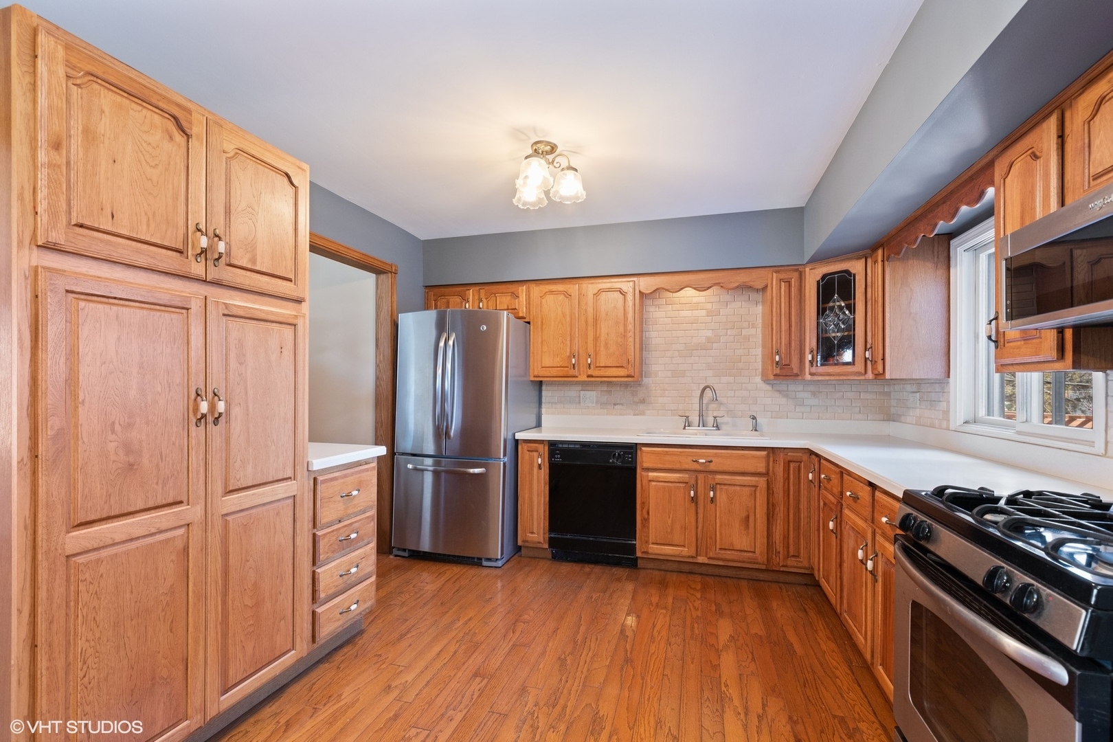 355 Chenault Road Buffalo Grove, IL 60089 - Photo 3 of 26 a large kitchen with stainless steel appliances granite countertop a stove and a refrigerator