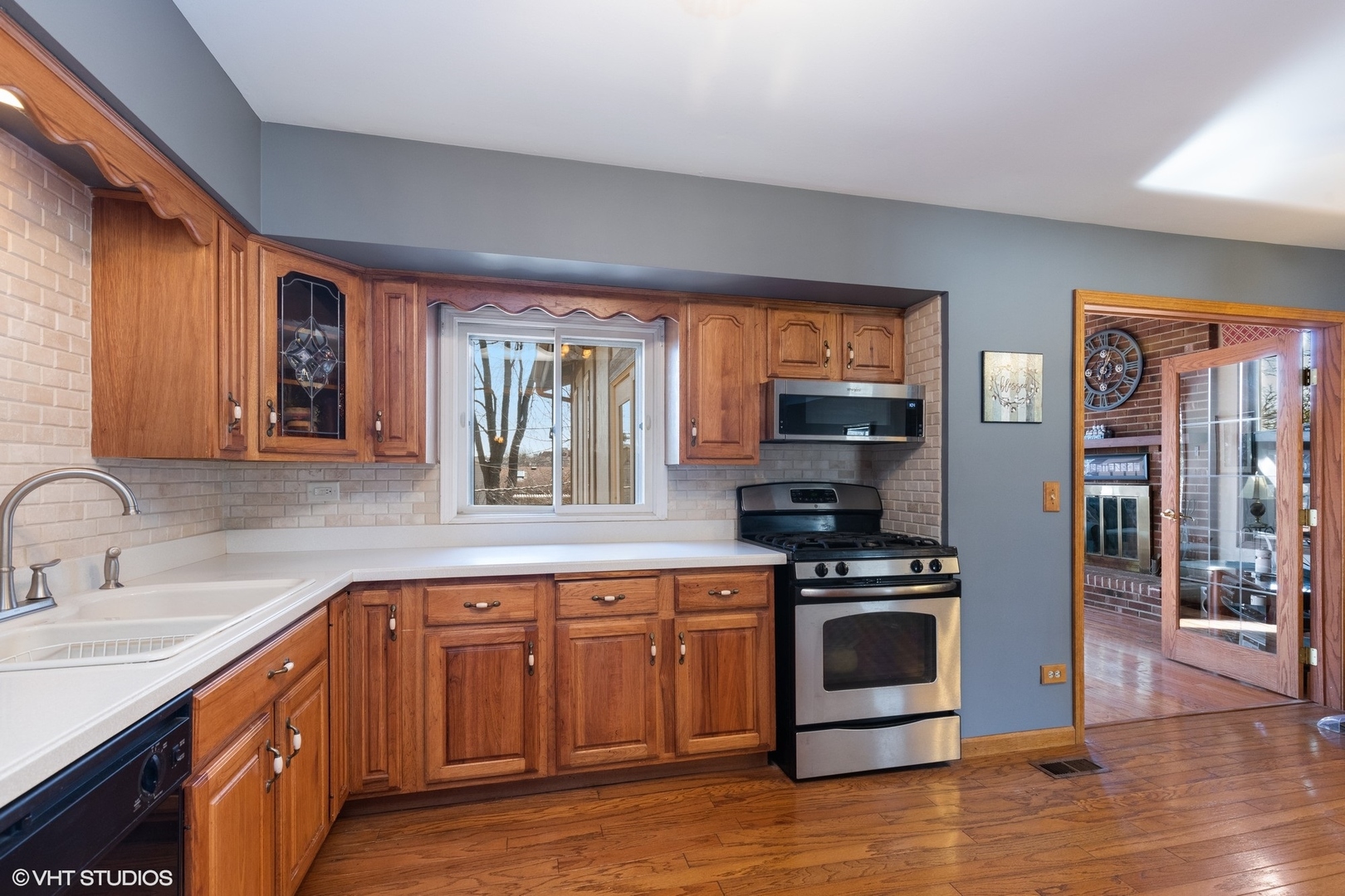 355 Chenault Road Buffalo Grove, IL 60089 - Photo 5 of 26 a kitchen with stainless steel appliances granite countertop a stove a sink and a microwave
