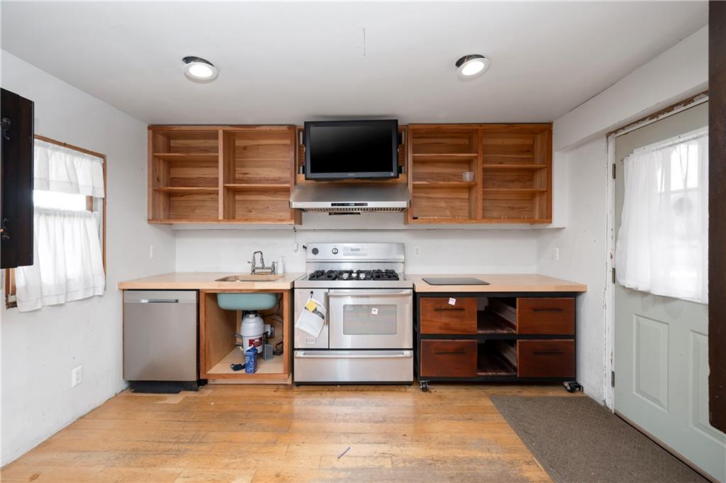 438 Main Street Prospect, PA 16052 - Photo 12 of 46 a kitchen with stainless steel appliances a stove a microwave and a sink