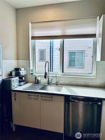 a kitchen with a sink and cabinets