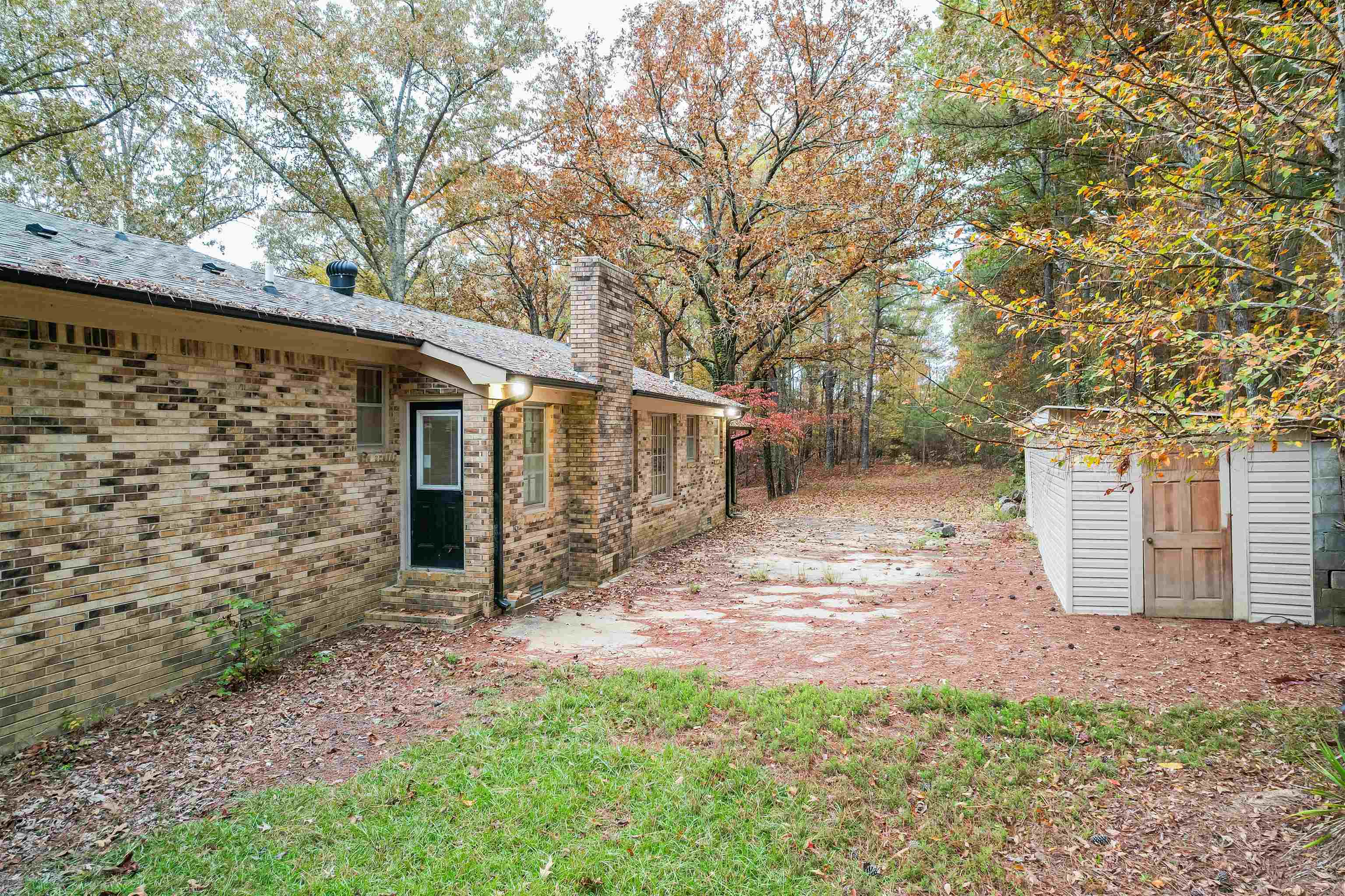 567 South 6th Street Selmer, TN 38375 - Photo 11 of 31 View of yard featuring a storage unit and a patio