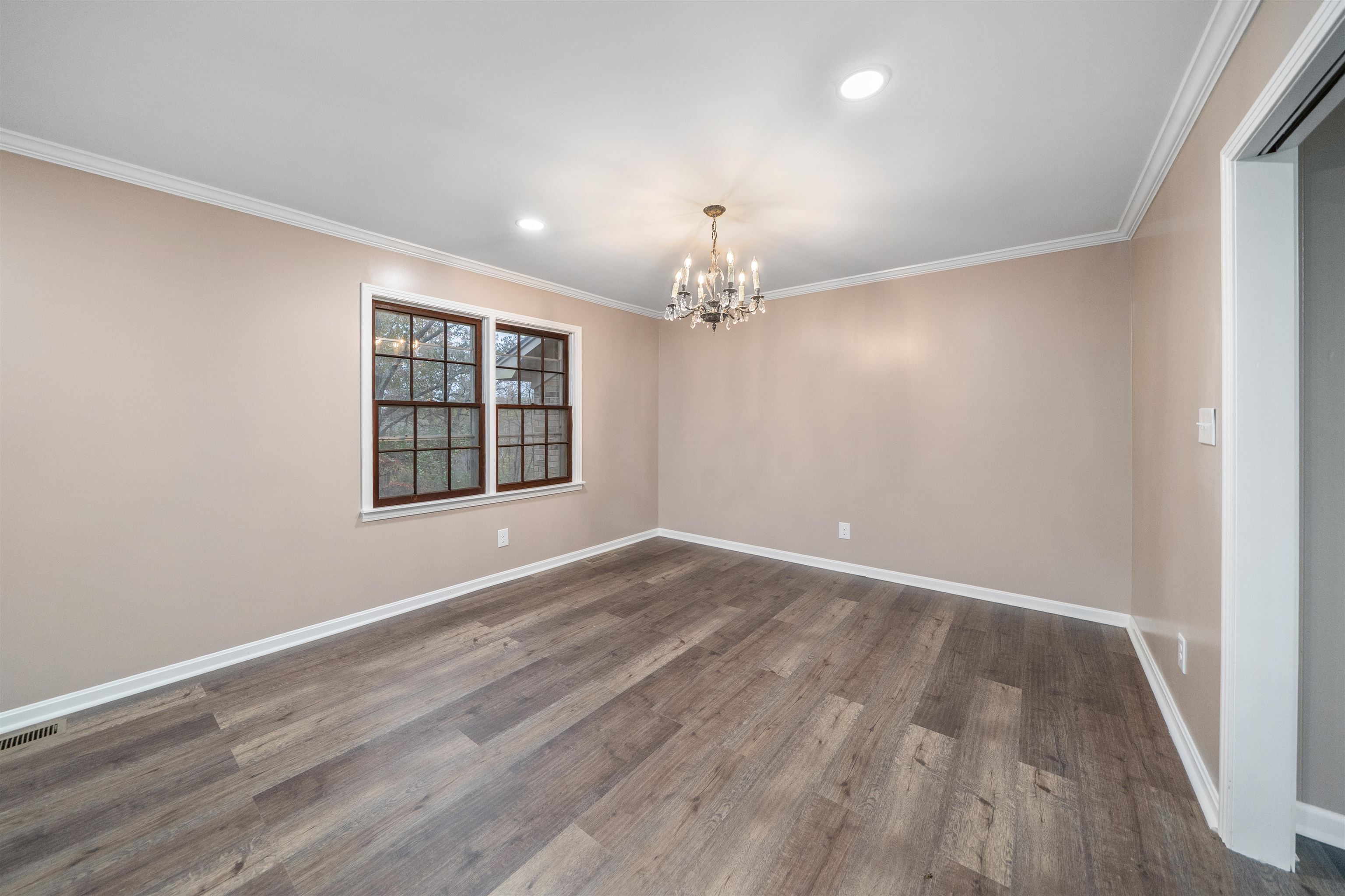 567 South 6th Street Selmer, TN 38375 - Photo 15 of 31 Spare room with ornamental molding, a chandelier, recessed lighting, and wood finished floors