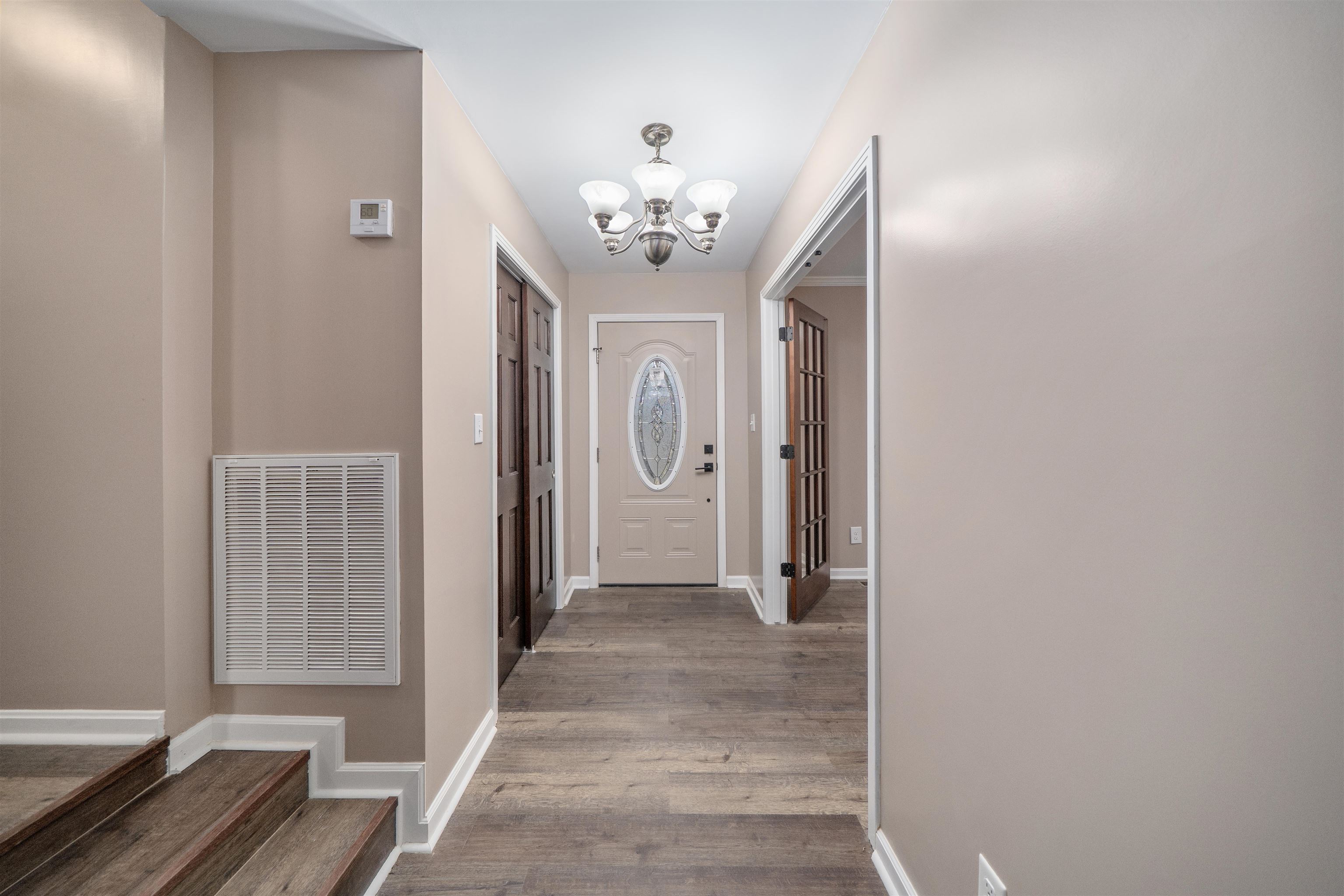 567 South 6th Street Selmer, TN 38375 - Photo 17 of 31 Entrance foyer with a chandelier, wood finished floors, and stairway