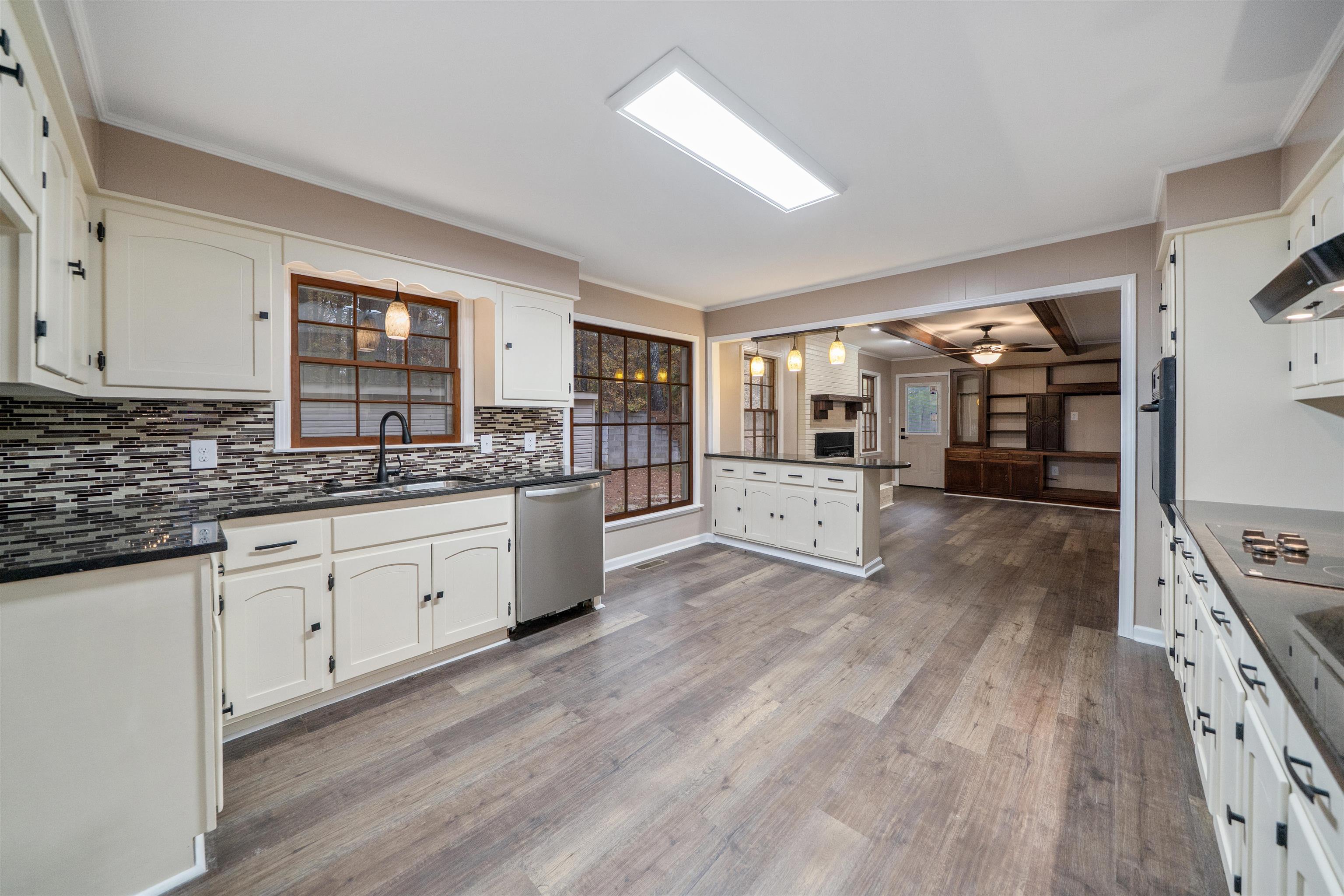 567 South 6th Street Selmer, TN 38375 - Photo 21 of 31 Kitchen with ornamental molding, decorative light fixtures, white cabinetry, and black appliances