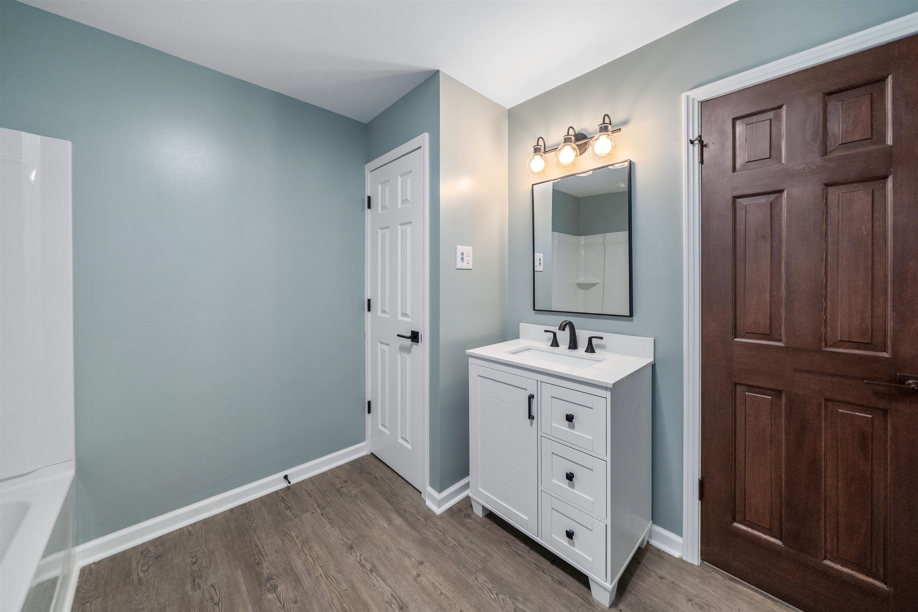 567 South 6th Street Selmer, TN 38375 - Photo 26 of 31 Full bath with vanity and light wood-style floors
