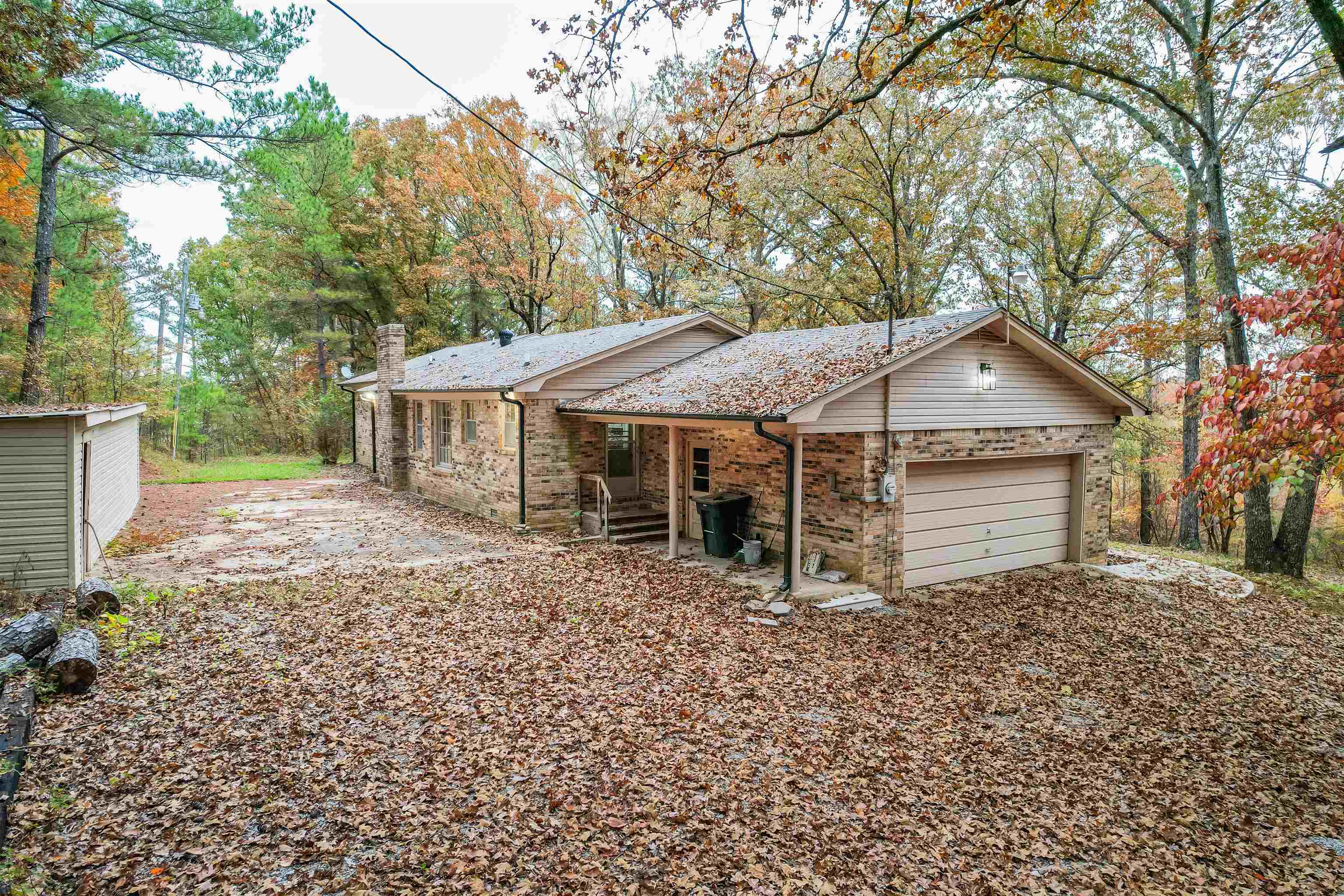 567 South 6th Street Selmer, TN 38375 - Photo 10 of 31 Rear view of house featuring brick siding, a garage, and driveway
