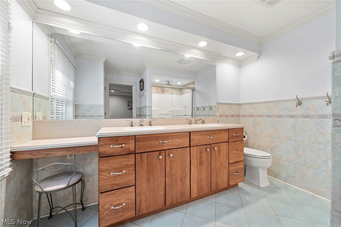 3871 Greentree Road Stow, OH 44224 - Photo 24 of 50 Bathroom vanity with dual sinks, wood-finish cabinetry, and a full-width mirror
