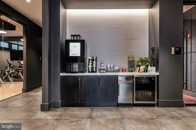 a view of a patio with couches table and chairs with potted plants and palm trees