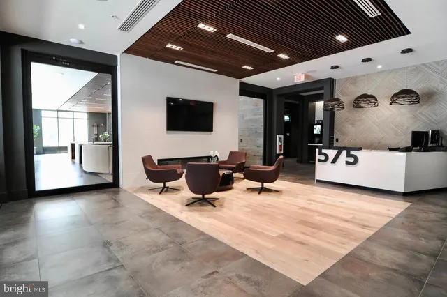 a kitchen with a refrigerator a sink and cabinets