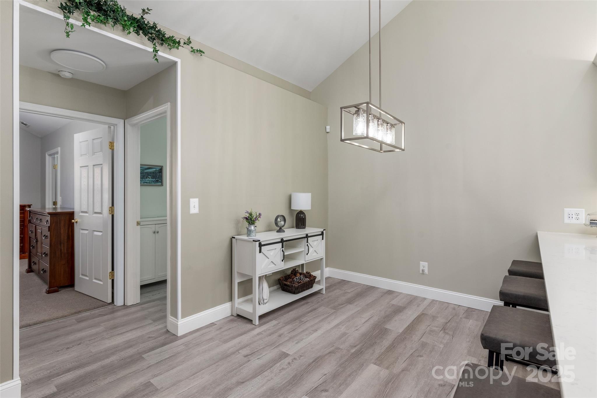 874 Ledgestone Court Tega Cay, SC 29708 - Photo 12 of 38 a view of a livingroom with wooden floor and a chandelier