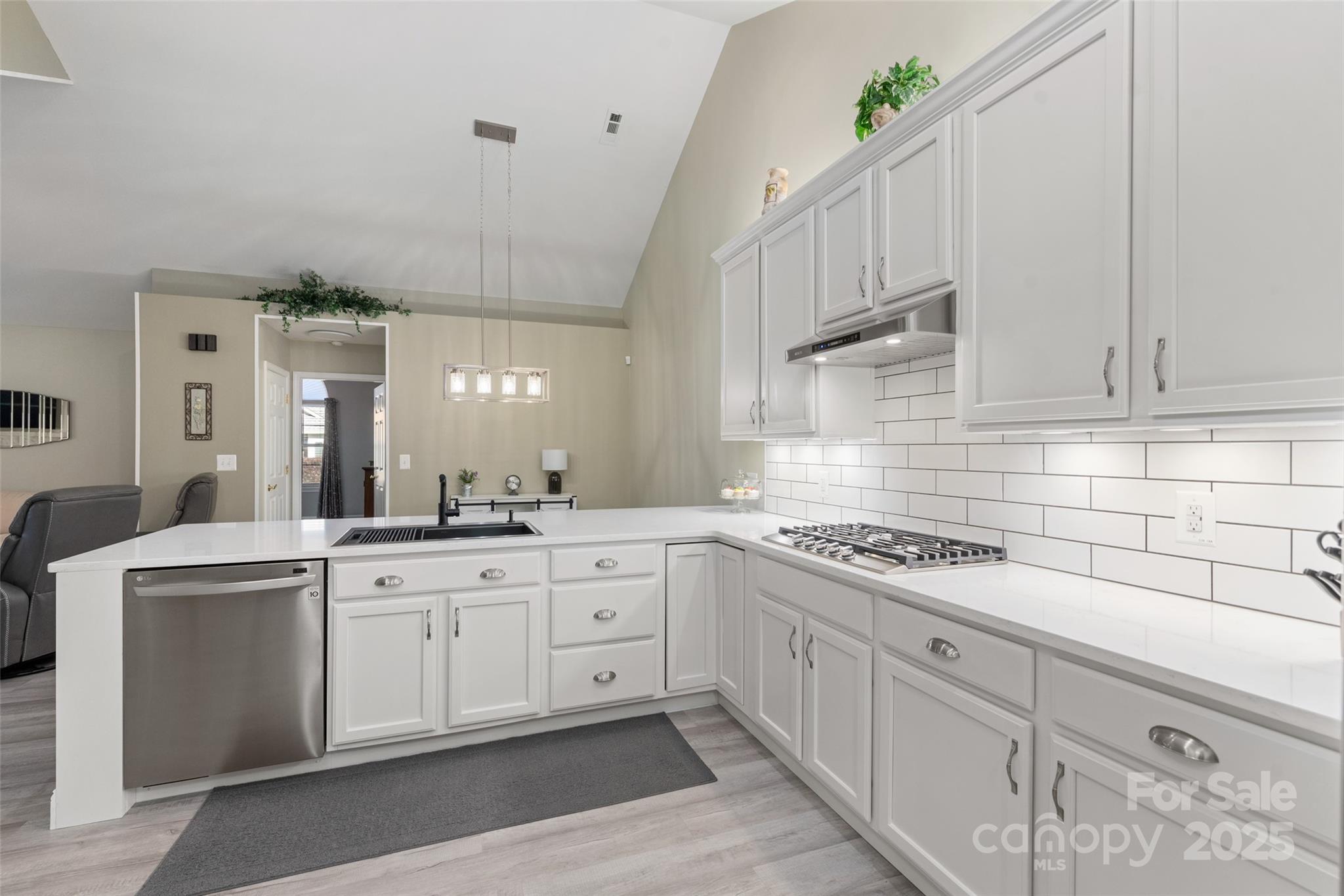 874 Ledgestone Court Tega Cay, SC 29708 - Photo 14 of 38 a kitchen with white cabinets and white appliances
