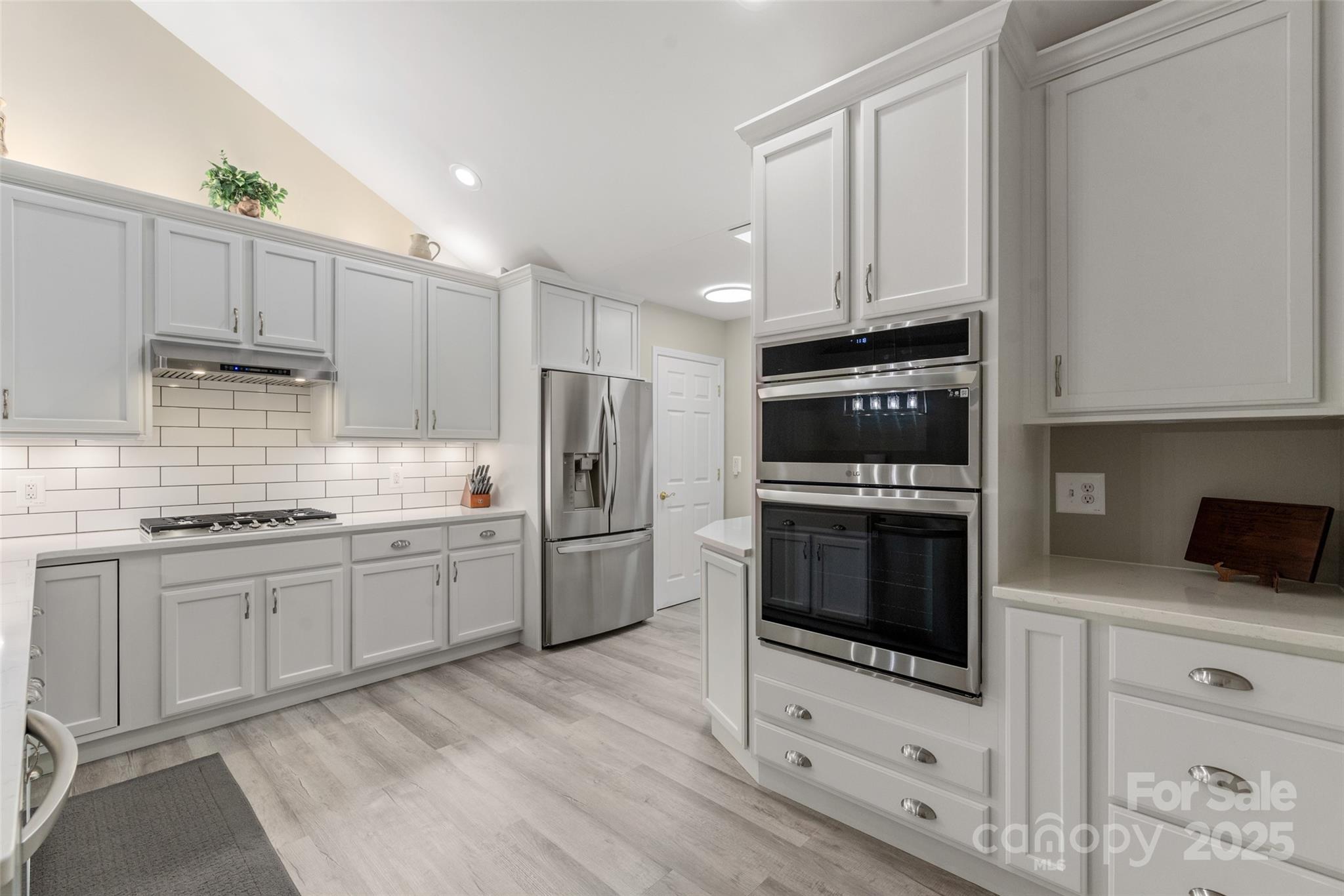874 Ledgestone Court Tega Cay, SC 29708 - Photo 16 of 38 a kitchen with granite countertop a refrigerator stove and oven