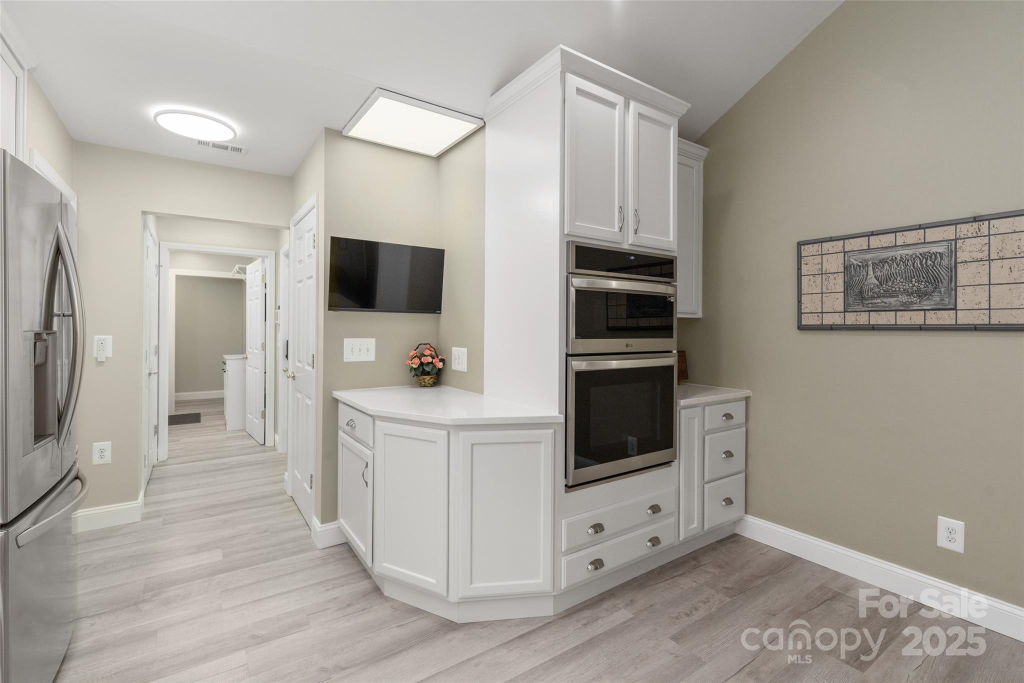 874 Ledgestone Court Tega Cay, SC 29708 - Photo 17 of 38 a view of kitchen with wooden floor electronic appliances and wooden floor