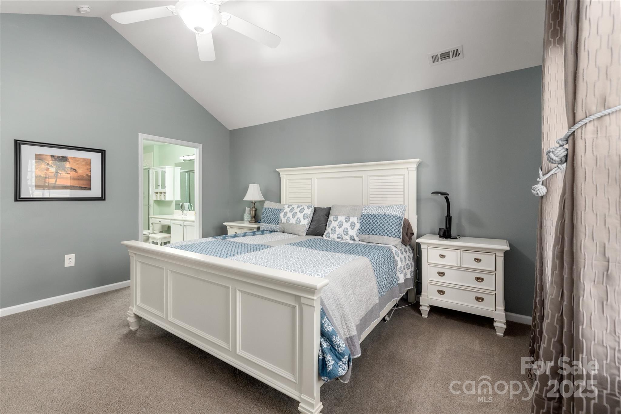 874 Ledgestone Court Tega Cay, SC 29708 - Photo 19 of 38 a bedroom with a bed and a chandelier