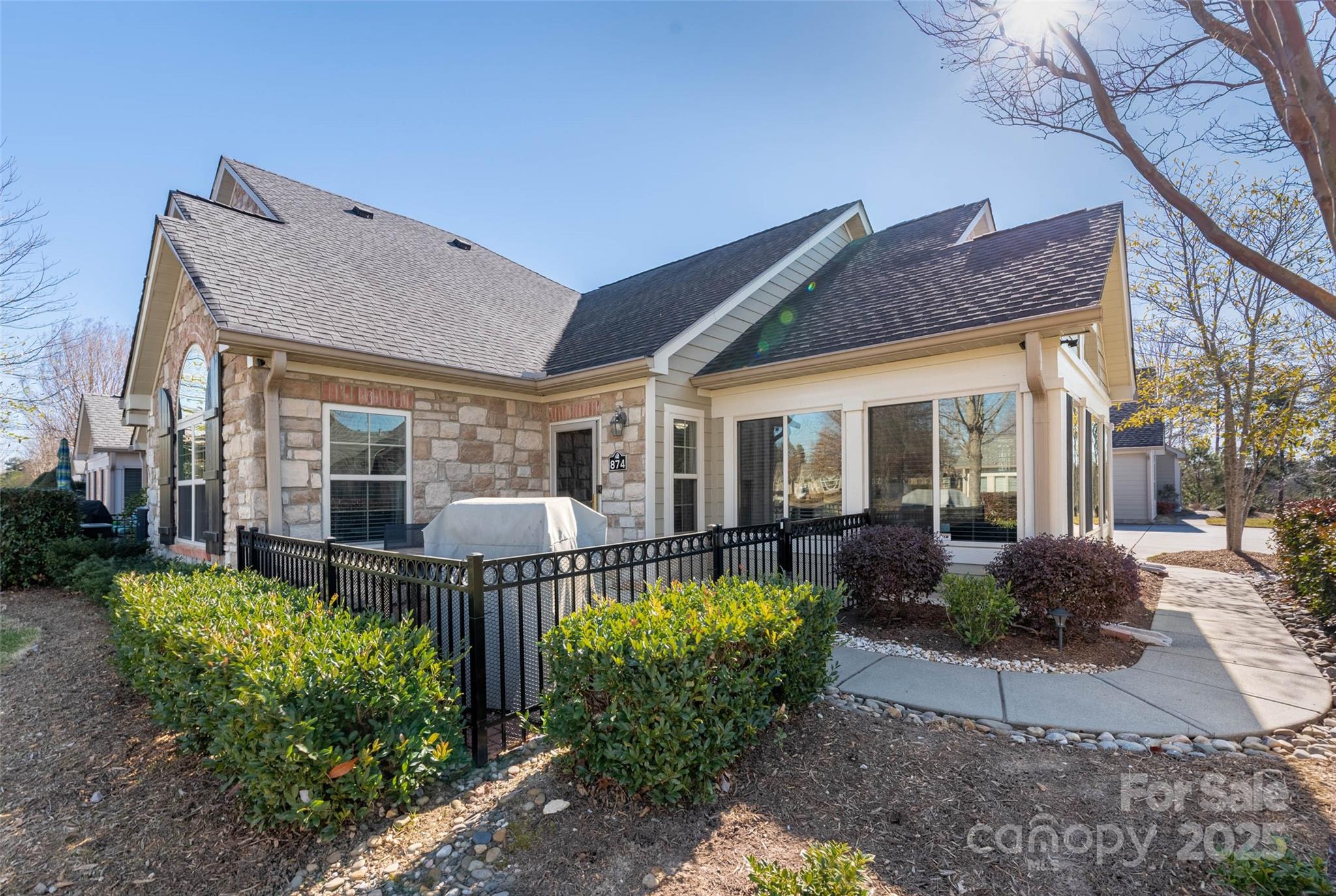 874 Ledgestone Court Tega Cay, SC 29708 - Photo 2 of 38 a view of a house with backyard sitting area and garden