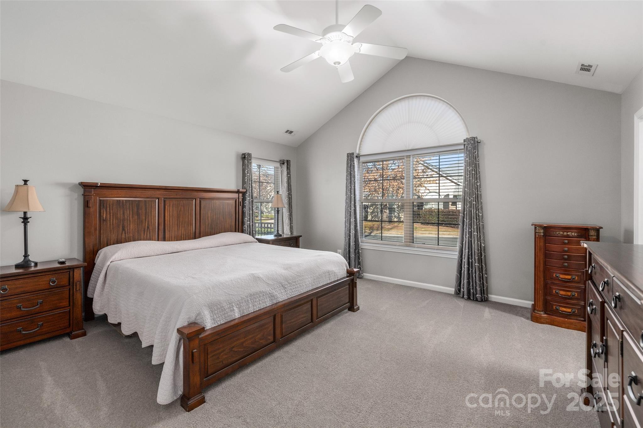 874 Ledgestone Court Tega Cay, SC 29708 - Photo 23 of 38 a bedroom with a bed and a chandelier