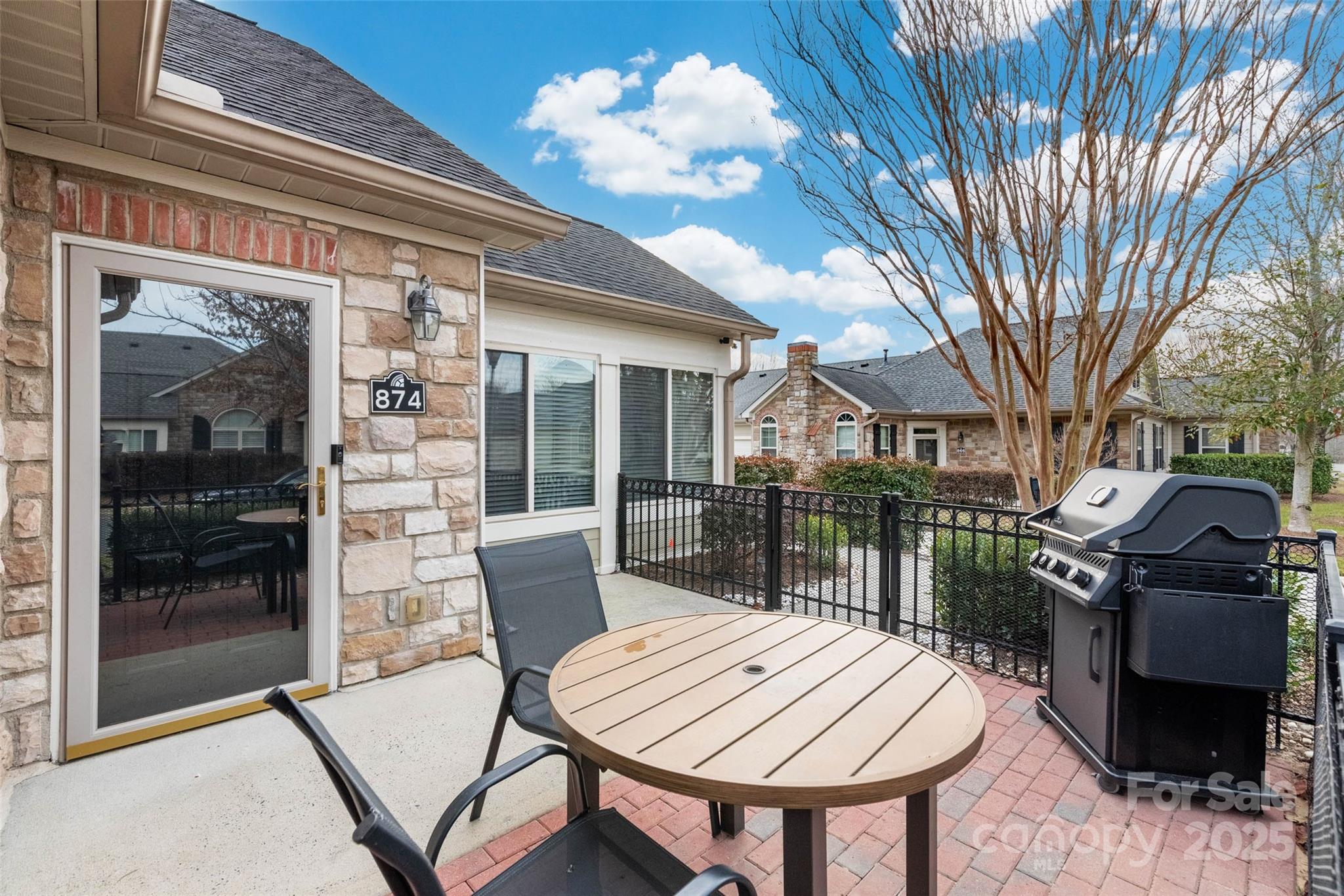 874 Ledgestone Court Tega Cay, SC 29708 - Photo 3 of 38 a view of a patio with a table and chairs and a barbeque