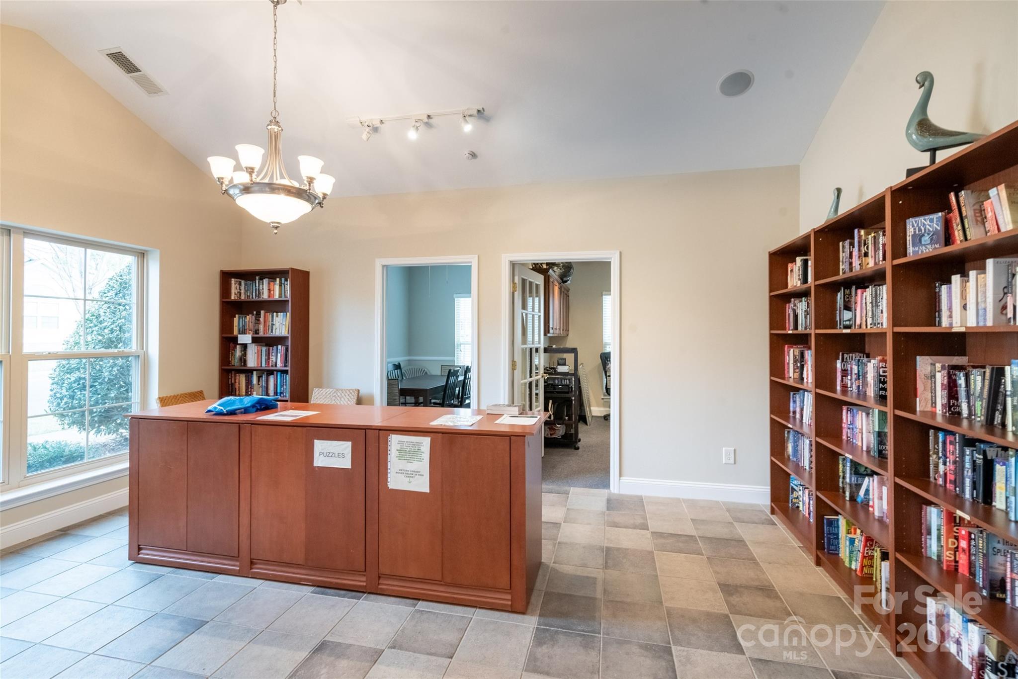 874 Ledgestone Court Tega Cay, SC 29708 - Photo 31 of 38 a living room with a book shelf and a book shelf