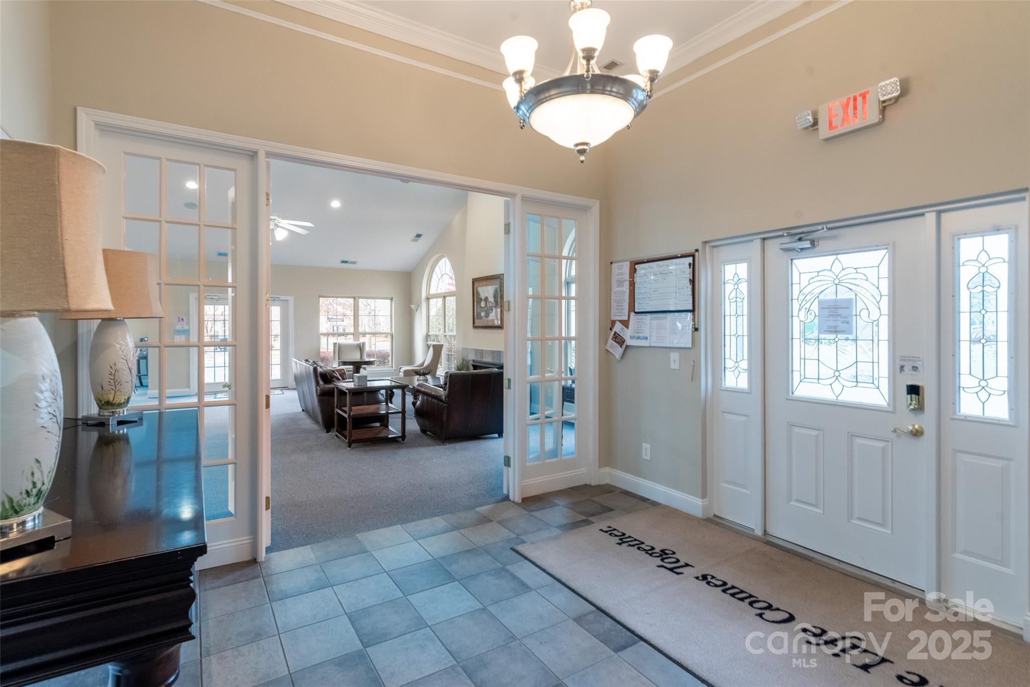 874 Ledgestone Court Tega Cay, SC 29708 - Photo 34 of 38 a view of a livingroom with furniture a chandelier and kitchen view