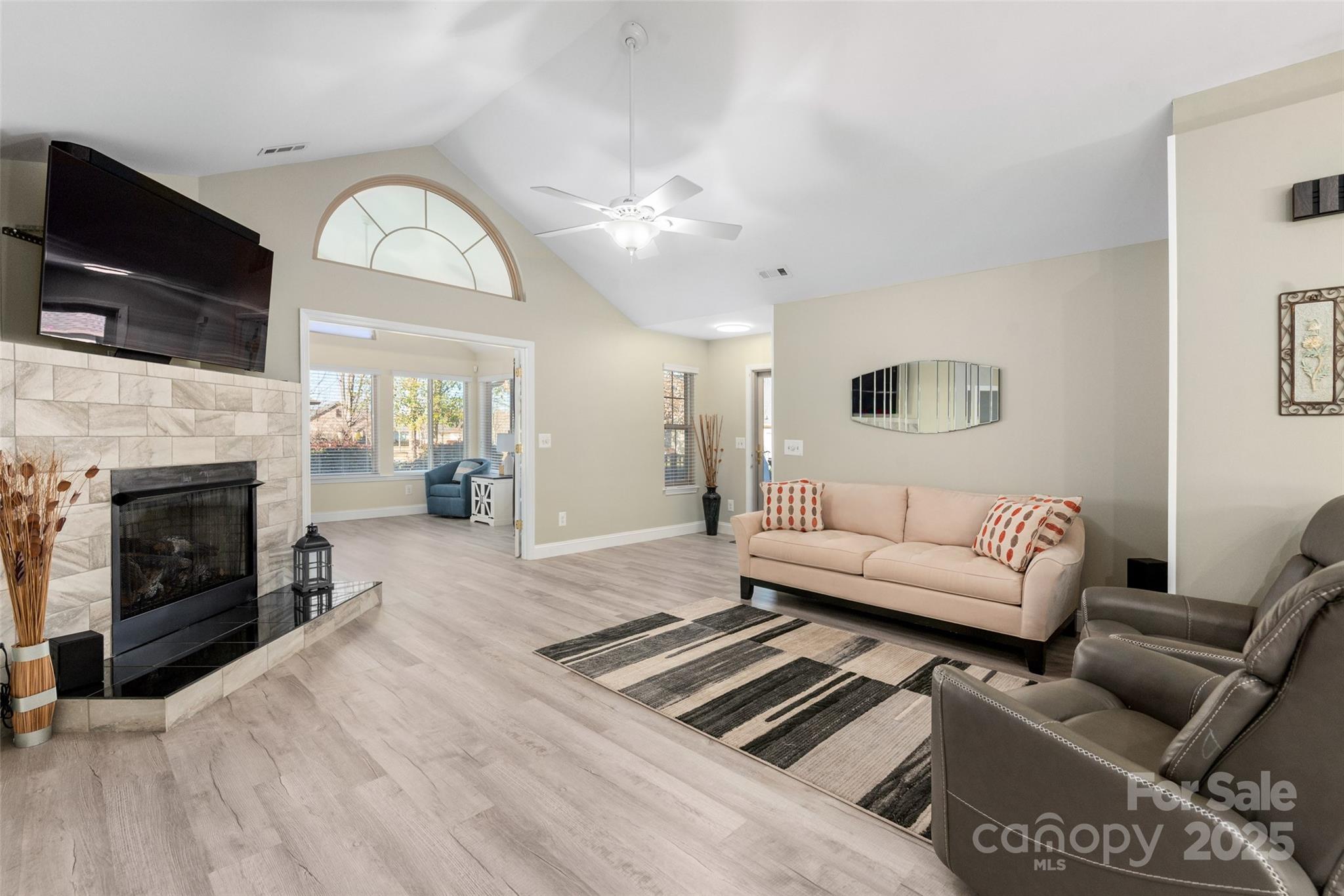 874 Ledgestone Court Tega Cay, SC 29708 - Photo 8 of 38 a living room with furniture a fireplace and a flat screen tv