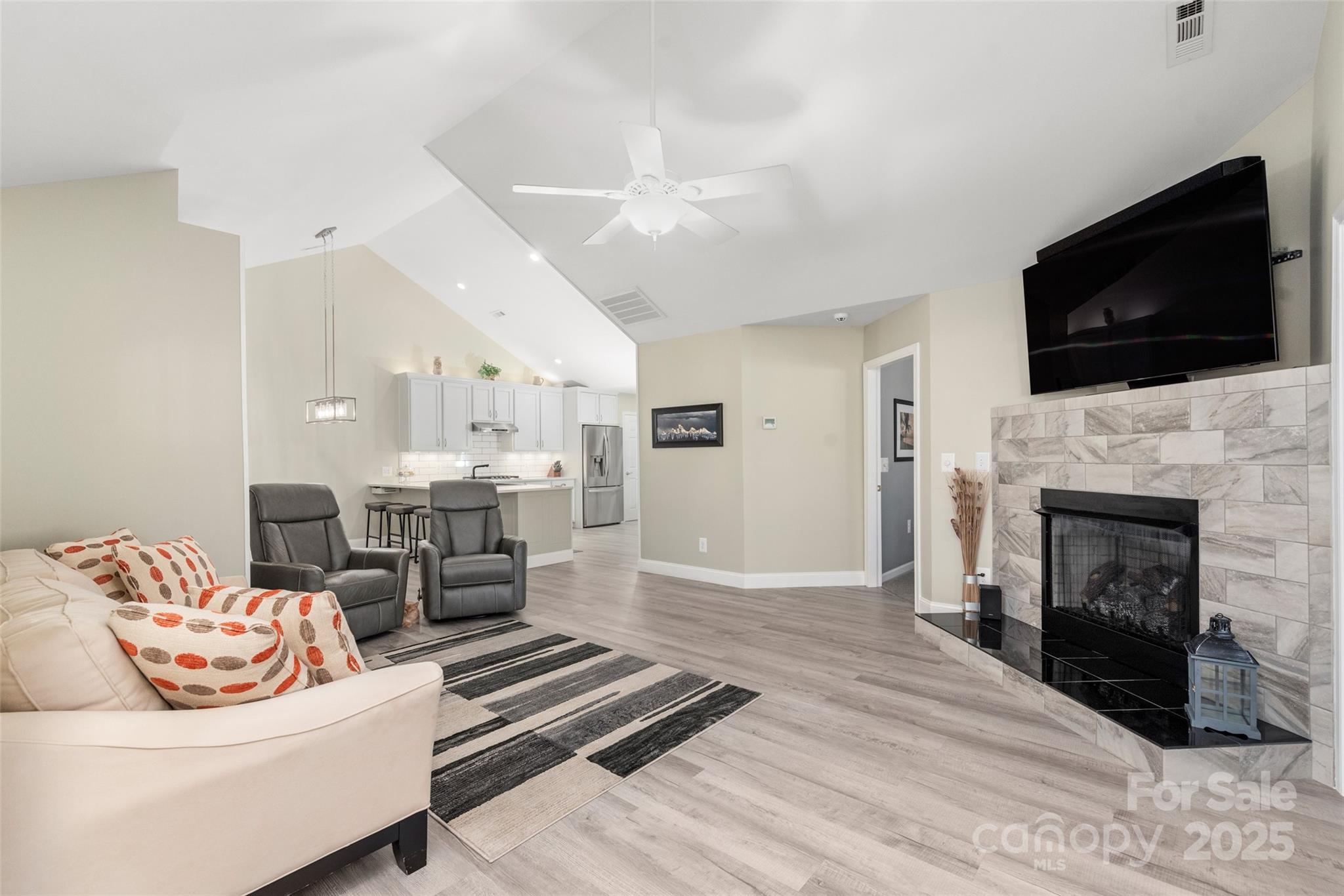 874 Ledgestone Court Tega Cay, SC 29708 - Photo 10 of 38 a living room with furniture fireplace and flat screen tv
