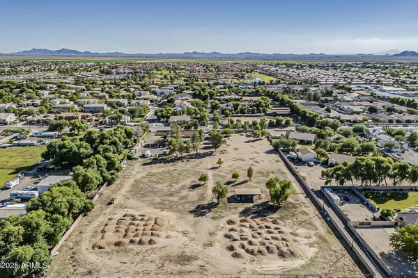 an aerial view of a residential houses with car parked