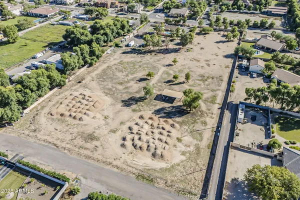 an aerial view of a house with a yard and trees