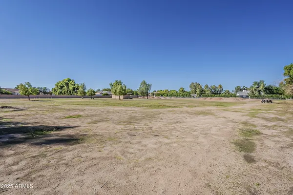 an aerial view of residential houses with outdoor space and street view