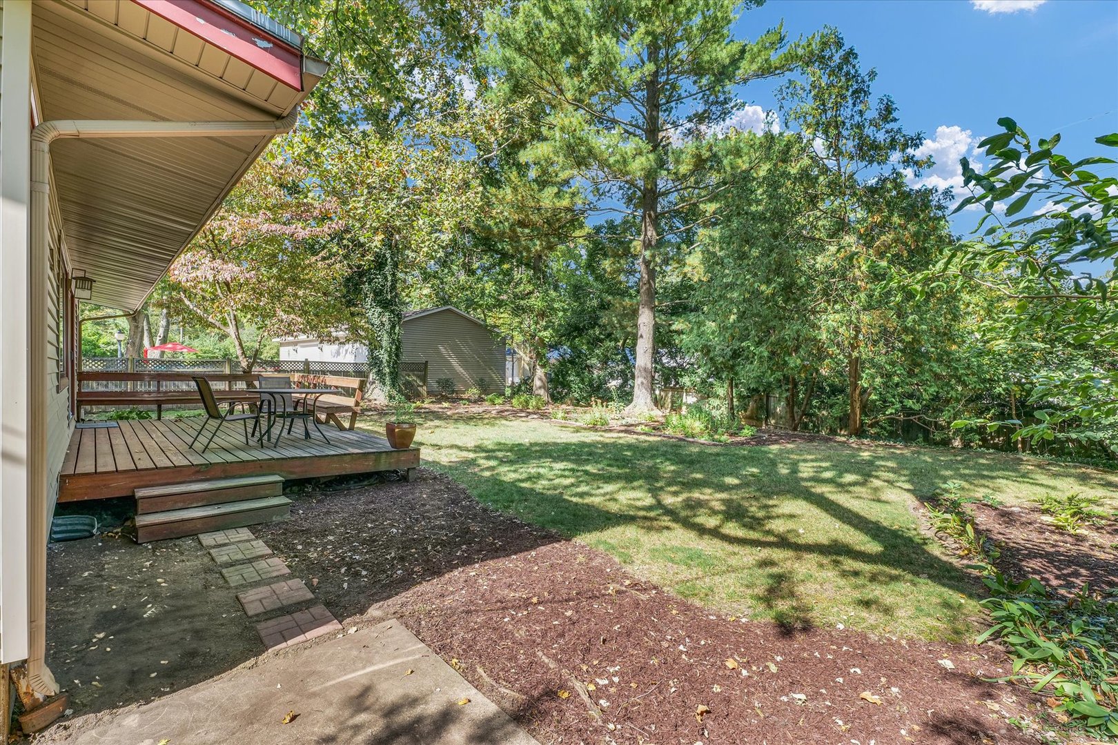 1505 Alma Drive Champaign, IL 61820 - Photo 43 of 50 a view of a yard with plants and a bench