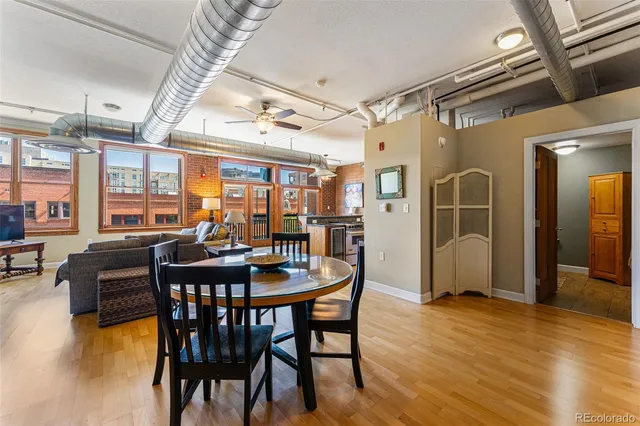 a view of a dining room with furniture window and wooden floor