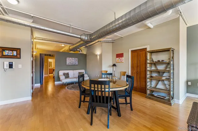 a view of a dining room with furniture and wooden floor