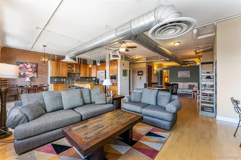 a living room with furniture a ceiling fan and a rug